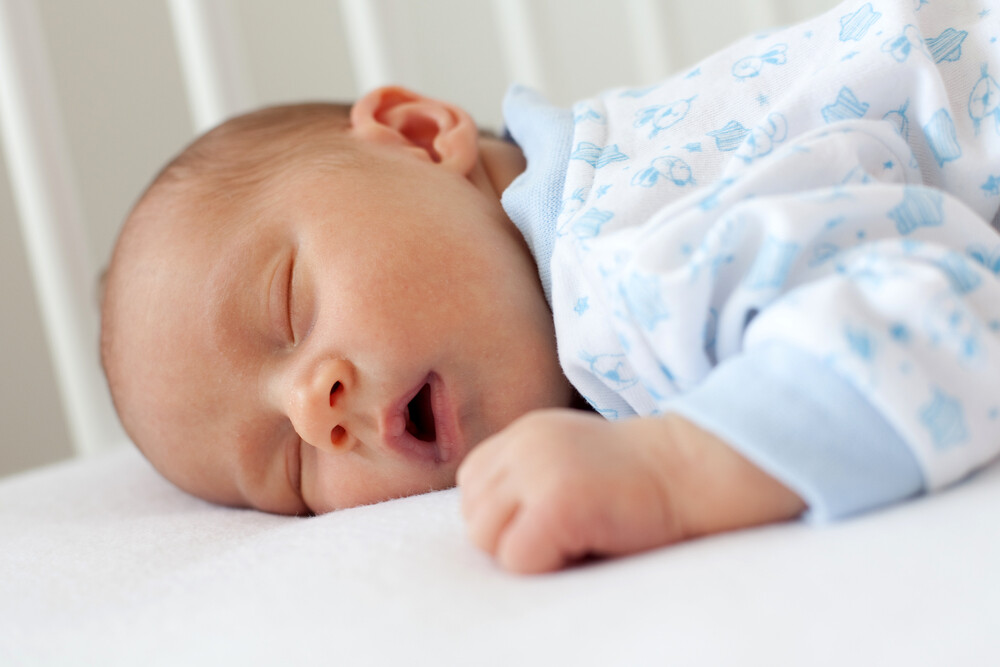 Baby sleeps with his mouth open.